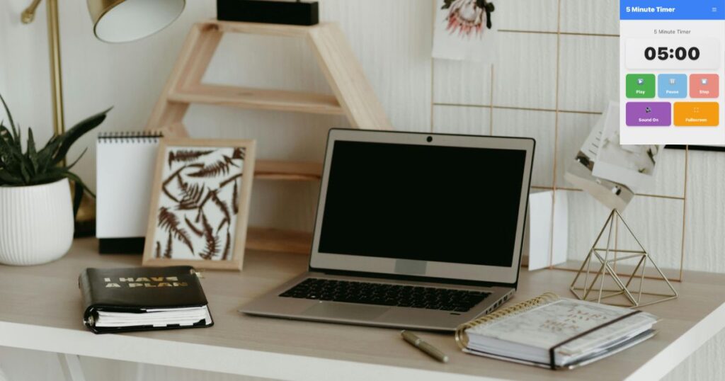 Productive workspace with laptop and 5 minute timer online displayed for time blocking and focused work