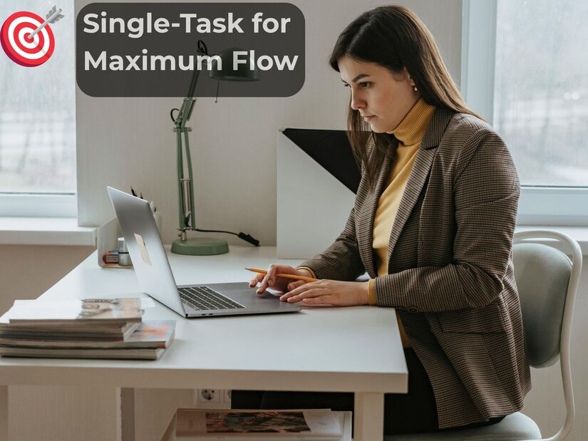 Woman in focused work session demonstrating single-task productivity with laptop at modern workspace