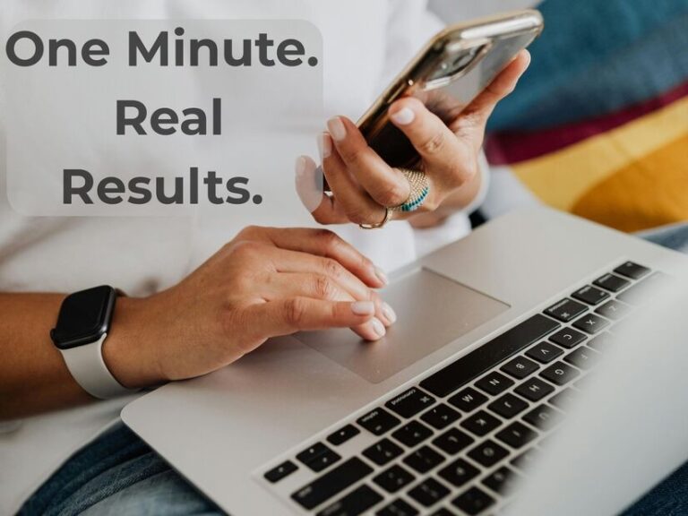 Close-up of a focused person using a smartphone and laptop, managing time-sensitive tasks in a casual setting.