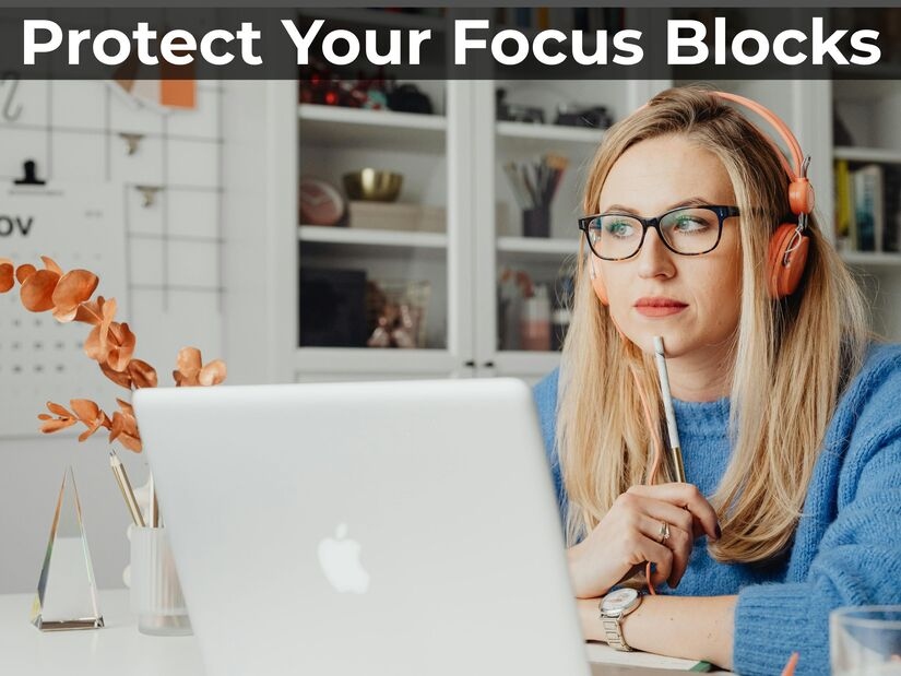 professional, focused on laptop work in quiet minimal workspace demonstrating protected time block concentration
