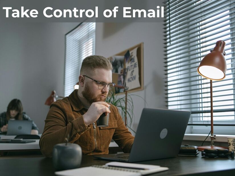 Person following email management routine at organised desk, demonstrating productive inbox control with a timed processing schedule