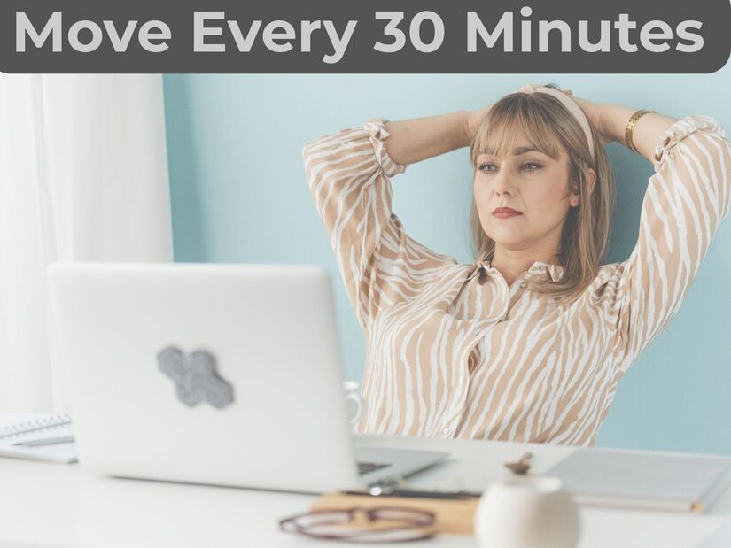 Professional doing desk stretches showing how long work breaks should be for physical and mental recovery

