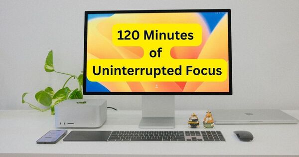 A clean, minimalist office desk with a computer displaying a 2 hour timer for uninterrupted focus, perfectly capturing the essence of a deep work session.
