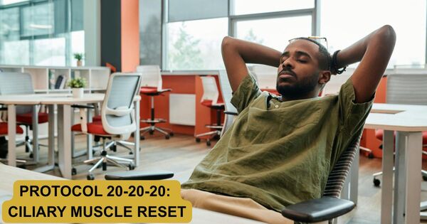 A professional leaning back at a modern office desk with eyes closed to execute a 20 minute timer visual recovery protocol.
