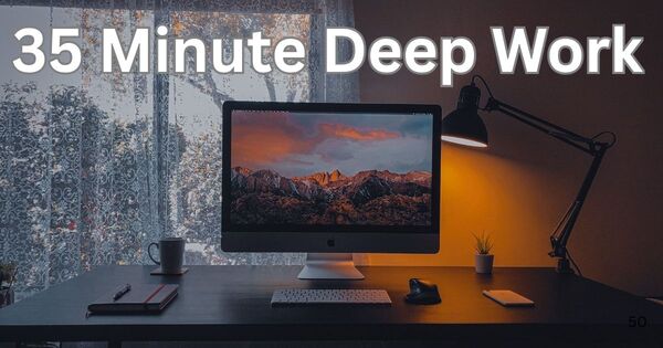 A professional desk setup featuring a computer monitor displaying a 35 minute timer for improved productivity.