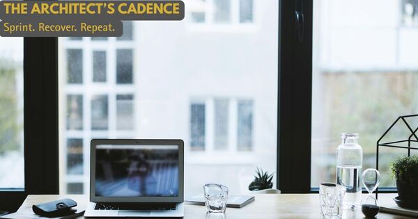 A minimalist workspace featuring an hourglass and laptop, representing the Architect’s Cadence of focused work and renewal.