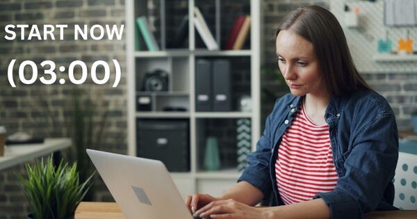A professional using a 3 minute timer application on a laptop to overcome task resistance and eliminate procrastination loops.