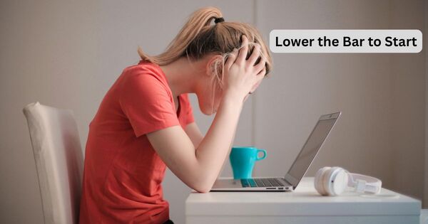 A person feeling overwhelmed at a desk with creative block, used to illustrate the benefits of a 5 minute timer