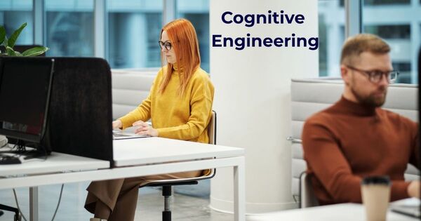 A woman in a yellow sweater working in an office environment to demonstrate the concept of cognitive engineering and deep focus techniques.