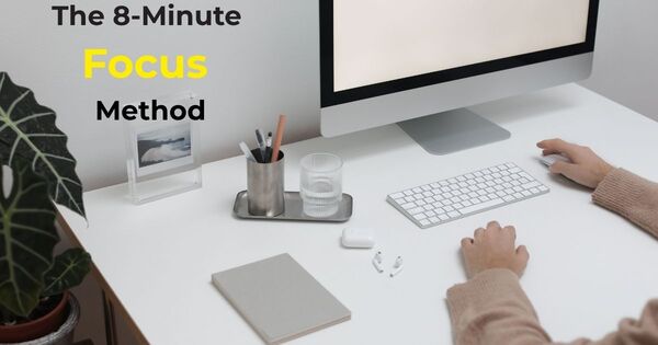 Minimalist workspace with an 8-minute timer and notebook, representing an organized, focused work environment.