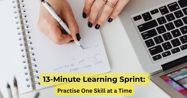 Person writing by hand during a 13-minute learning sprint at a desk with a laptop