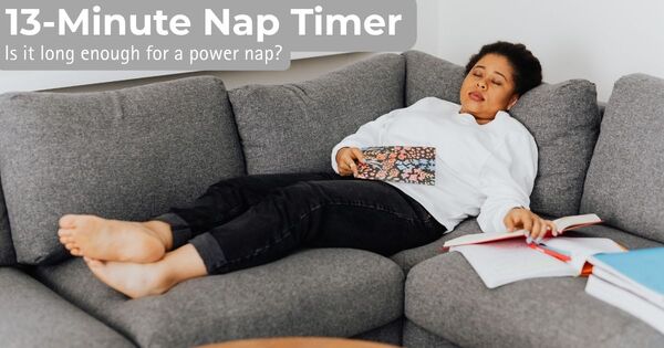 A person resting on a sofa with books while using a 13-minute nap timer.
